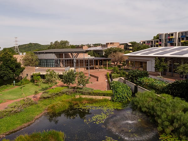 Future Africa Institute campus buildings with pond in the foreground