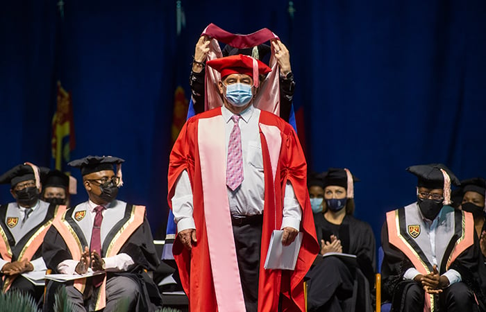 Emeritus Professor Jacobus Andries Wynand (Koos) Coetzer receiving his honorary doctorate on stage during a UP graduation ceremony.