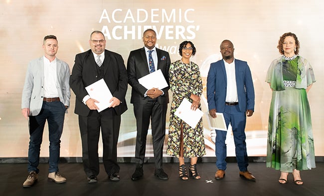 A group of UP academics pose with awards at Academic Achievers Awards ceremony