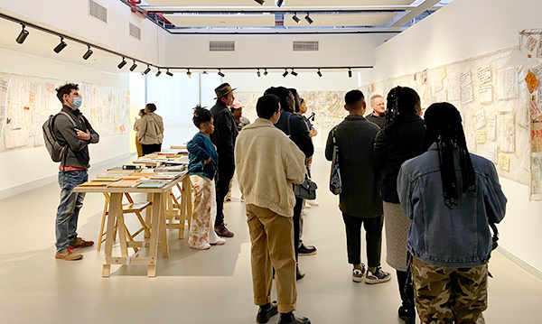 A diverse group of visitors contemplate the ARAC exhibition at the Javett-UP Art Centre