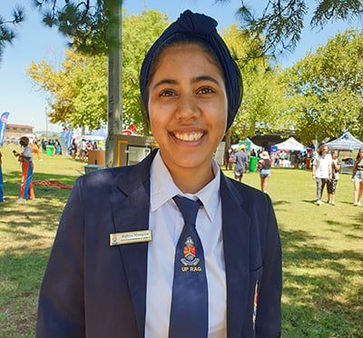 Rafeea Mangera, University of Pretoria RAG Vice-Chairperson and Events, wears a navy blue turban, tie and blazer with a white shirt