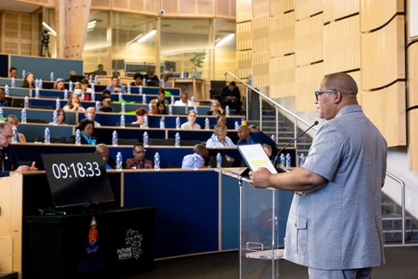 UP Interim Vice-Chancellor and Principal Prof Themba Mosia stands before delegates seated in an auditorium and delivers the opening address at the 2023 Diabetes Summit hosted by UP and the Diabetes Alliance.