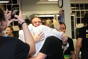 Emotional students hugging each other