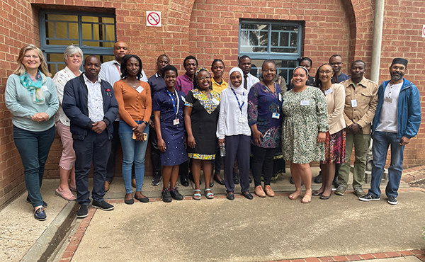 Staff from the University of Pretoria's postgraduate scholarship office and bursary recipients pose for a picture.  