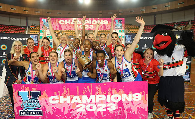 Jubilant TuksNetball team members pose for a picture with the trophy
