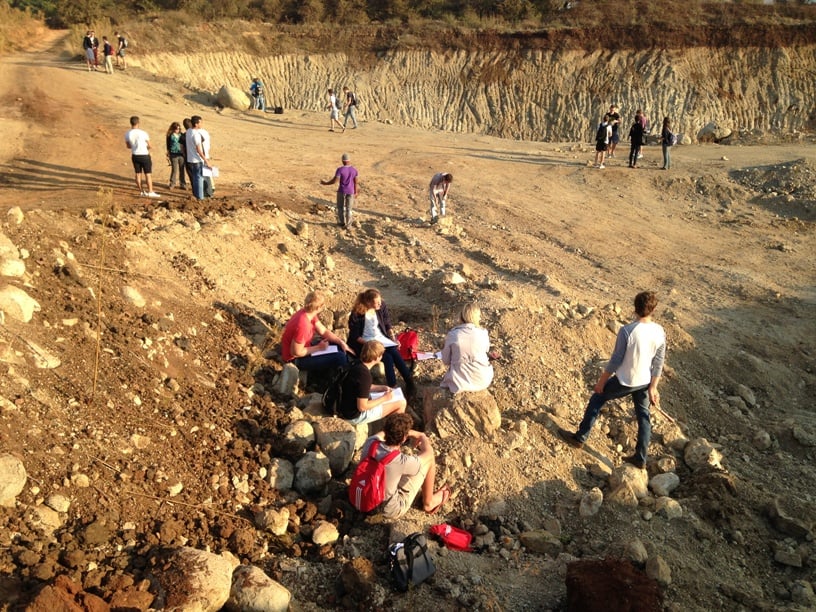 Scattered 2nd year civil engineering students from TUKS against a background of dry, beige, loose to medium dense sand and gravel from residual norite