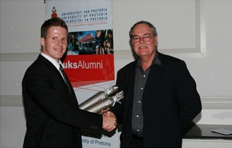 Professor Maritz is presented with a gift by Charl Marais